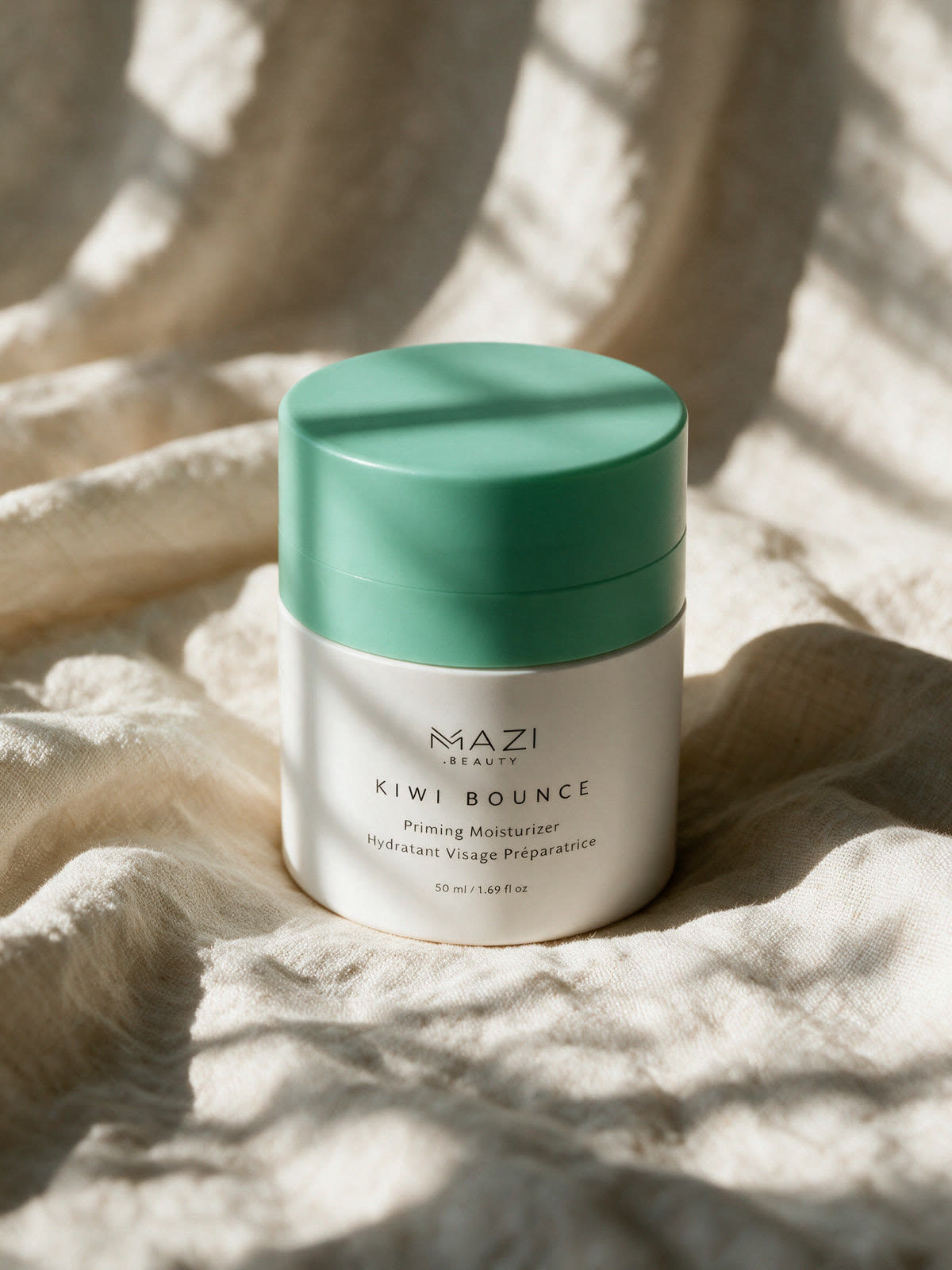 The closed Kiwi Bounce jar resting on linen in daylight
