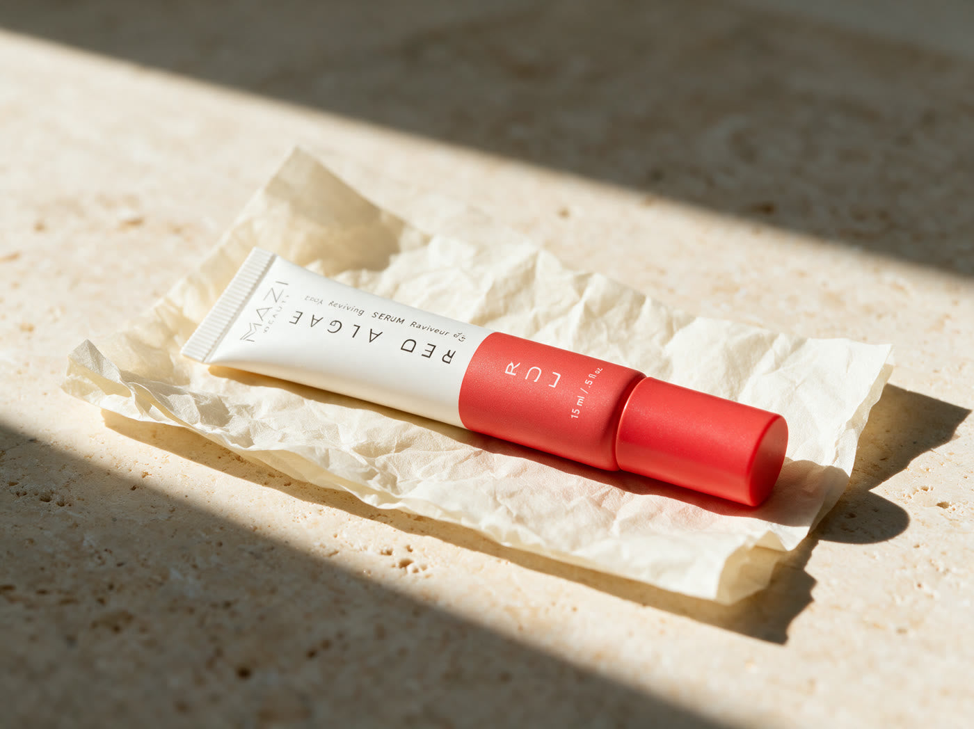 The closed LUR Red Algae tube resting on a sheet of plain unbleached tissue paper